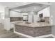 Modern kitchen with white cabinets, granite countertops, and stainless steel appliances at 10020 Sw 202Nd Cir, Dunnellon, FL 34431