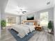 Main bedroom with light wood furniture and patio access at 10020 Sw 202Nd Cir, Dunnellon, FL 34431