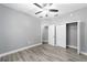 Spacious bedroom with ceiling fan, walk-in closet, and wood-look flooring at 10020 Sw 202Nd Cir, Dunnellon, FL 34431