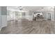 Open concept living area with vinyl flooring and access to kitchen at 10020 Sw 202Nd Cir, Dunnellon, FL 34431