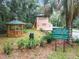 Community gazebo with picnic tables and nearby guard house with posted rules at 10020 Sw 202Nd Cir, Dunnellon, FL 34431