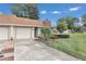 Tan house with a driveway and landscaping at 2309 Se 19Th Cir, Ocala, FL 34471