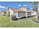 Rear exterior view showing a well-maintained house and a screened-in porch at 2309 Se 19Th Cir, Ocala, FL 34471