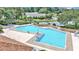 Inviting community pool with ample lounge chairs and surrounding landscape at 2309 Se 19Th Cir, Ocala, FL 34471
