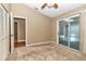 Bedroom with carpeting, ceiling fan, and access to a lanai at 2309 Se 19Th Cir, Ocala, FL 34471