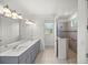 Modern bathroom with double vanity, large mirror, and walk-in shower at 10145 Sw 89Th Loop, Ocala, FL 34481