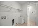 Bright laundry room with utility sink and shelving at 10145 Sw 89Th Loop, Ocala, FL 34481