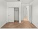 Empty bedroom with carpeted floor, closet, and door to hallway at 10145 Sw 89Th Loop, Ocala, FL 34481