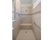 Walk-in shower with tiled walls, built-in seat, and grab bar at 10145 Sw 89Th Loop, Ocala, FL 34481