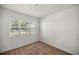 Simple bedroom with neutral carpeting and large window at 10145 Sw 89Th Loop, Ocala, FL 34481