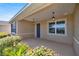 Covered front porch with double doors and pendant lighting at 10145 Sw 89Th Loop, Ocala, FL 34481