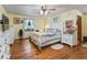 Bright bedroom with wood floors, a ceiling fan, and white dresser at 4344 Cr 542H, Bushnell, FL 33513