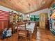 Rustic dining room features wood floors and a large wall tapestry at 4344 Cr 542H, Bushnell, FL 33513