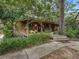 Charming wood home with a large porch surrounded by trees at 4344 Cr 542H, Bushnell, FL 33513
