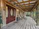 Covered porch with wooden rocking chairs and a view at 4344 Cr 542H, Bushnell, FL 33513