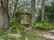 Peaceful garden setting with a wooden swing nestled amongst trees at 4344 Cr 542H, Bushnell, FL 33513