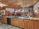 Open kitchen with large island, wood cabinets and granite countertops at 4344 Cr 542H, Bushnell, FL 33513