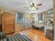 Home office space with wood floors, built-in shelves and large antique wardrobe at 4344 Cr 542H, Bushnell, FL 33513