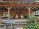 Covered porch with wooden furniture and a metal table at 4344 Cr 542H, Bushnell, FL 33513
