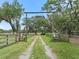 Long driveway entrance to property with wooden gate at 4344 Cr 542H, Bushnell, FL 33513