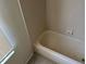 Clean bathroom featuring a bathtub and tile surround at 3817 Sw 161St Loop, Ocala, FL 34473