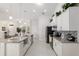 Modern kitchen featuring granite countertops, stainless steel appliances, and white cabinetry at 5005 Sw 106Th St, Ocala, FL 34476