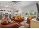 Bright living room features leather furniture and a large flat-screen TV at 5005 Sw 106Th St, Ocala, FL 34476