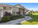 Landscaped front yard with walkway leading to a charming house entrance at 5005 Sw 106Th St, Ocala, FL 34476