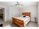Bedroom with wood queen bed and ceiling fan at 5005 Sw 106Th St, Ocala, FL 34476