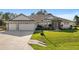 Beautiful house with three car garage and manicured lawn at 5005 Sw 106Th St, Ocala, FL 34476