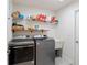 Bright laundry room, featuring washer, dryer, and utility sink at 5005 Sw 106Th St, Ocala, FL 34476