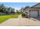 Side view of house showcasing a long driveway and walkway to the back yard at 5005 Sw 106Th St, Ocala, FL 34476