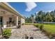 Covered patio with seating area overlooking the backyard and neighboring homes at 5005 Sw 106Th St, Ocala, FL 34476