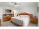 Large bedroom with king bed, wood furniture, and ceiling fan at 5005 Sw 106Th St, Ocala, FL 34476