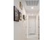 Bright hallway with light tile floors and framed pictures on the wall at 5005 Sw 106Th St, Ocala, FL 34476