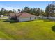 View of the house from the backyard showing a large grassy area and shed at 5005 Sw 106Th St, Ocala, FL 34476