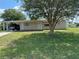 Single-story home with carport and a large front yard at 10061 Sw 88Th Ter, Ocala, FL 34481