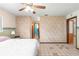 Main bedroom with ceiling fan, carpet, and ensuite access at 10061 Sw 88Th Ter, Ocala, FL 34481