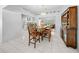 Spacious dining area with wooden table and chairs, adjacent to the kitchen at 13027 Ne 7Th Loop, Silver Springs, FL 34488