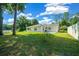 Spacious backyard with grassy area and patio, providing ample outdoor space at 13027 Ne 7Th Loop, Silver Springs, FL 34488