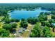 Aerial view showcasing the property's location near a lake in a wooded area at 13027 Ne 7Th Loop, Silver Springs, FL 34488