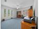 Bright home office with built-in shelving and large windows at 13027 Ne 7Th Loop, Silver Springs, FL 34488