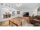 Living room with LVP flooring, leather furniture and view into dining area at 13027 Ne 7Th Loop, Silver Springs, FL 34488
