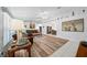 Spacious living room with wood-look floors, leather furniture, and a view of the dining area at 13027 Ne 7Th Loop, Silver Springs, FL 34488