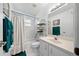 Clean bathroom with shower/tub combo, vanity, and linen storage at 13027 Ne 7Th Loop, Silver Springs, FL 34488