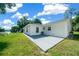 Large back patio with gray concrete and space for seating, overlooking the yard at 13027 Ne 7Th Loop, Silver Springs, FL 34488