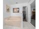 Relax in this bathroom's large garden tub, conveniently located near a walk-in closet at 13027 Ne 7Th Loop, Silver Springs, FL 34488