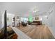 Open living room with vaulted ceiling, LVP flooring and leather furniture at 13027 Ne 7Th Loop, Silver Springs, FL 34488