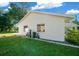 Side view of the house showcasing a clean, white exterior and landscaping at 13027 Ne 7Th Loop, Silver Springs, FL 34488