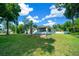 House exterior showcasing the side view and landscaping at 13027 Ne 7Th Loop, Silver Springs, FL 34488